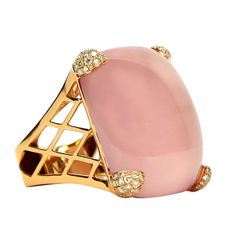 Simply Beautiful! Finely detailed Rose Quartz and Diamond Gold Cocktail Ring. Centering a large rectangular 65 Carat Cabochon Rose Quartz, Diamond set triangular-shaped prongs on 4 sides. Sixty-eight Diamonds, weighing approx. 0.68 total carats. Hand crafted 18k Pink gold lattice work, square base mounting. Approx. size Rose Quartz: 29.5mm x 24.5mm. Approx. total weight of ring: 25.1 gm. Ring size 8.5, we offer ring resizing.. More Beautiful in Real time! lassic and Chic...Illuminating your look Cocktail Ring Designs, Precious Rings, Jewellery Unique, Gorgeous Ring, Gold Cocktail Ring, Pearl And Diamond Earrings, Gold Cocktail, Cabochon Jewelry, Gold Diamond Earrings