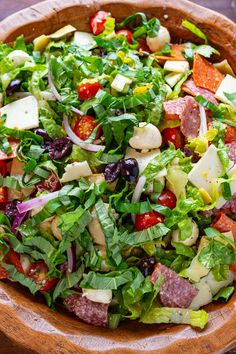 a salad in a wooden bowl on a table