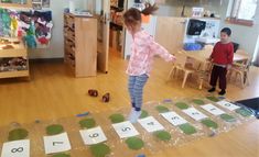 two children are playing with letters and numbers on the floor