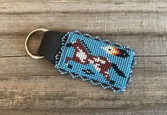 a keychain made out of bead and leather with a cartoon character on it