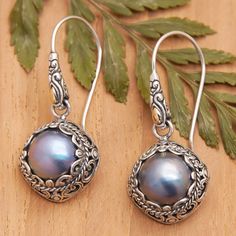 Two exquisite cultured Mabe pearls in a lovely blue hue are encapsulated by intricate engraved sterling silver motifs in this pair of fabulous dangle earrings designed by Bali's Dewi Putera. Featuring subtle 18k gold-plated accents, the heavenly earrings are sure to catch the eye and fill any attire with sophistication. Mabe Pearl, Pearl Dangle Earrings, Pretty Jewelry, Pearl Earrings Dangle, Pretty Jewellery, Blue Hues, Designer Earrings, Gold Accents, Jewelry Earrings Dangle