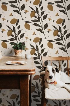 a dog laying on a chair in front of a wallpapered dining room table