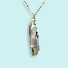 A slender, curved abalone handled knife with a semi sharp blade on a gold curb chain. Metal: Stainless steel knife, 14kt gold-filled chain Size: 1.25"L knife Lobster Clasp Material: Abalone Available in 16", 18", and 20" chain (18" Fits Most) Natural materials will vary Chain is made in the USA, Knife is made in China Word to the wise: This is a real knife and the blade is sharp. Don't wear it with the knife open. Keep it out of reach of children. Use caution when opening and closing it (if you've never opened a pocket knife, please take a minute to find a YouTube video to learn). Gold Compass Necklace, Knife Necklace, Abalone Necklace, Gold Curb Chain, Moon Necklace Silver, State Necklace, Compass Necklace, Out Of Reach, Silver Chain Bracelet