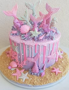 there is a cake decorated with pink and purple decorations