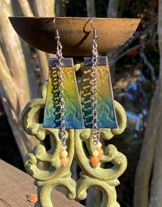 "Handmade Geometric Tooled Leather Earrings in Aqua & Yellow with Natural Peach Aventurine & Peridot Jasper  This pair of lovely earrings are hand tooled and hand dyed in aqua shades fading into yellow ombré style.  They are adorned with 2 dripping chains a piece, both with natural stone beads.  The findings are antiqued/aged and have gunmetal ear wires.   Total Length: Approx 3.75\" -Dangle Length: Approx 3\" -Width: Approx 1.5\" Welcome to our caravan! We are purveyors of fine adornments, carefully curated unique finds, and lovely curiosities.  Our leather boutique is composed of handmade art, some of which have been created from personally harvested stones and even repurposed components.  Our vintage side is full of found eclectic items procured to awaken the bohemian soul within you. Tooled Leather Earrings, Peach Aventurine, Yellow Ombre, Ombre Fashion, Natural Stone Beads, Jasper Beads, Tooled Leather, Lovely Earrings, Leather Items