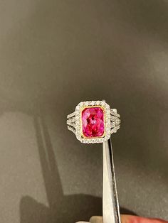 Oval cut pink sapphire weighing 3.06cts mined in Madagascar in a bright electric pink color and certified by Stone Group Laboratories.  The stone is bezel set in 18kt yellow gold and the ring is 18kt white gold bead set with round beautiful cut diamonds weighing approximately 1.30cts with clarity and color approximately VS1, F-G. This ring can be sized to your speciations. Pink Diamond Cut Diamond Ring, Pink Emerald Cut Diamond Ring, Pink Diamond Ring With Fine Jewelry Style, Pink Diamond Rings With Diamond Cut, Pink Gia Certified Diamond Ring For Formal Occasions, Formal Pink Gia Certified Rings, Dazzling Pink Ruby Ring As A Gift, Pink Baguette Cut Diamond Ring For Formal Events, Pink Baguette Cut Diamond Ring For Anniversary