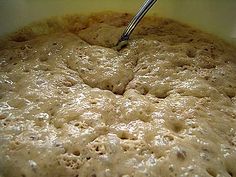 a bowl full of batter with a spoon in it