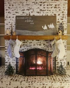 a fireplace with stockings hanging from the mantle