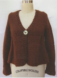 a mannequin wearing a brown cardigan with a white button on the front