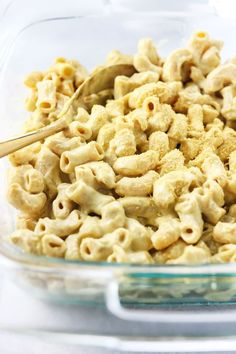 a glass bowl filled with macaroni and cheese