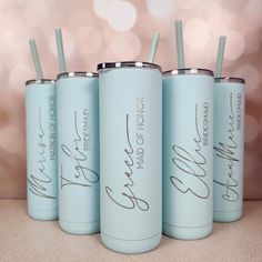 four personalized tumblers with straws in them