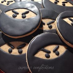 cookies decorated with black and white icing sitting on top of a table