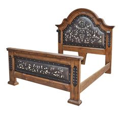 a wooden bed frame with intricate carvings on it