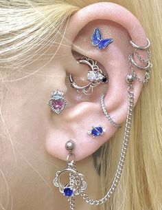 a close up of a person with ear piercings on their ears and behind the ear