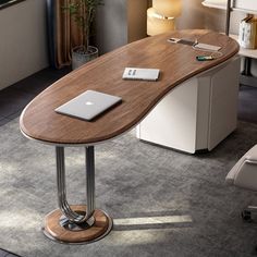 a laptop computer sitting on top of a wooden desk next to a chair in a living room