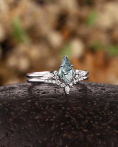 a close up of a ring on top of a rock