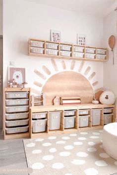 a child's playroom with toys and storage bins on the wall, along with white polka dot rug