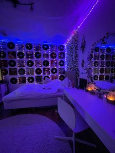 a bedroom with purple lights and lots of records on the wall