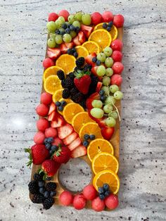 a letter made out of fruits and berries