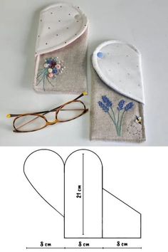 a pair of glasses sitting on top of a piece of fabric next to a bag