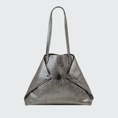 Akris metallic shoulder bag in hammered leather. Approx. 18.50"H x 12.20"W x 5.12"D; 11.42" drop. Two flat shoulder straps. Open top. Folded sides secure at turn-lock front. Interior, two zip pockets. "AI" is imported. Designer Silver Textured Leather Shoulder Bag, Structured Shoulder Bag With Palladium Hardware For Everyday Use, Silver Business Shoulder Bag With Detachable Strap, Luxury Silver Shoulder Bag For Business, Modern Silver Shoulder Bag For Business, Modern Silver Bag For Business, Luxury Metallic Shoulder Bag With Palladium Hardware, Evening Satchel With Gunmetal Hardware And Double Handle, Luxury Metallic Shoulder Bag For Daily Use