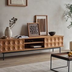 a living room scene with focus on the coffee table and sideboard in the foreground