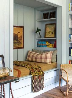 a room with some bookshelves and pictures on the wall