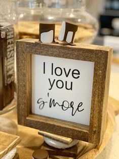 there is a sign that says i love you and more on the table with other items