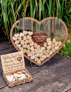 a heart shaped box filled with lots of wine corks next to a card board