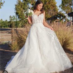 a woman in a white wedding dress holding a bouquet