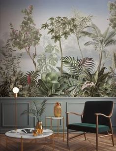 a living room with a large mural on the wall and two chairs in front of it