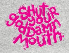 the words'stuff your damn mouth'are painted in pink on a gray shirt