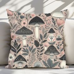 a pillow with mushrooms and flowers on it