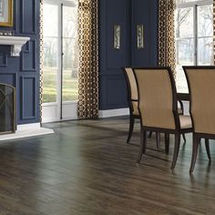 a dining room with blue walls and wood floors