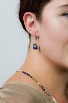 Discover the vibrant and stunning colors of the Blue Moon Collection in these eclectic earrings! Gold Filled (Lead & Nickel Free) Pyrite, Sodalite, Lapis Lazuli, Labradorite 1" with gold filled ear wires We hand select our natural materials, thus there may be slight variations in color and/or size that will not detract from the overall aesthetic. Our unique handcrafted designer jewelry for women is made in America, each design created individually in our personal design studio in Floyd, VA USA Eclectic Earrings, Floyd Va, The Blue Moon, Silver Gold Earrings, Silver Gold Necklace, Pyrite Necklace, Moon Collection, Beaded Jewelry Patterns, Cluster Earrings