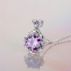 Sparkling and elegant, this purple necklace is perfect for that special evening out. Created in sterling silver, it features a round cut stone sparking at its center, while additional round stones line the sterling silver settings for extra shimmer. An imaginative look you'll adore, this necklace is unsurpassed with magnificence and sparkle.Carat Weight: 8.5 ctStone Size: 11 mmStone Type: Jeulia® StoneNumber of Stones: 1 Stone Shape: RoundStone Color: Amethyst PurpleCarat Weight: 2.658 ctStone S Elegant Round Purple Jewelry, Exquisite Purple Necklace As A Gift, Exquisite Purple Jewelry, Purple Jewelry With Center Round Stone, Purple Jewelry With Round Center Stone, Purple Round Jewelry With Center Stone, Purple Jewelry With Round Accent Stones, Purple Round Jewelry With Accent Stones, Purple Cubic Zirconia Necklace For Formal Occasions