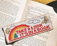 a bookmark that says take a look it's in a book