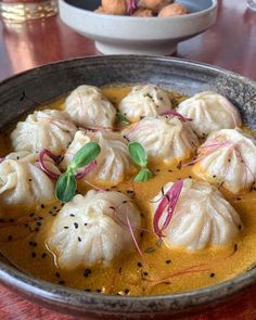 some dumplings are sitting in a bowl on a table