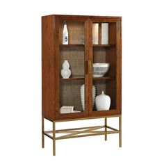 a wooden cabinet with glass doors and shelves on the bottom shelf, holding two white vases