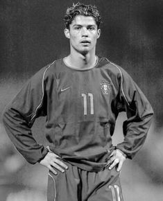 a black and white photo of a soccer player with his hands on his hips, looking at the camera