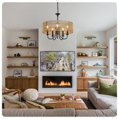 a living room filled with furniture and a fire place under a chandelier hanging from the ceiling