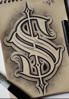 a drawing of a dollar sign on a piece of paper with marker pens next to it