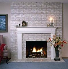 a living room with a white brick fireplace and blue carpet