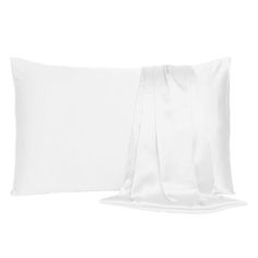 the white pillow is laying next to it's satin ribboned edges on an off - white background