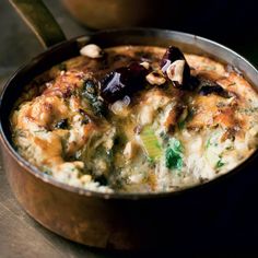 a pot filled with food sitting on top of a table