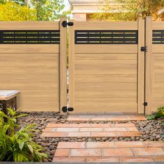 two wooden gates in front of a brick walkway