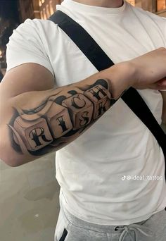 a man with a cross tattoo on his arm