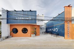 the building is made out of shipping containers and has an awning over it's entrance