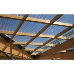 the inside of a building with wooden beams and skylights on it's roof