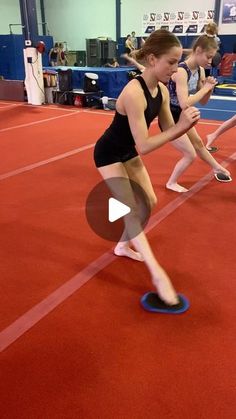 two girls are running on a red floor